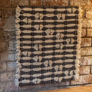 Cassandra Smith: ShadowForm III, textured, handwoven acoustic wall panel featuring wool and mixed fibres in a repeat pattern in cream and black