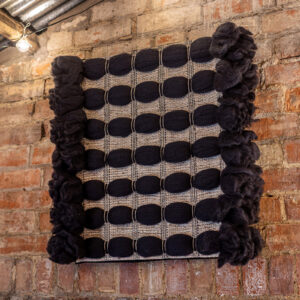 Cassandra Smith: ShadowForm I, textured handwoven acoustic wall panel featuring wool, cotton, linen, wire and paper yarn and wool roving fibres.