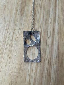 Joy Cecilia Taylor: Silver cutwork necklace.