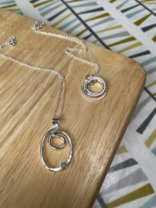 Joy Cecilia Taylor: Circular worked silver necklaces.