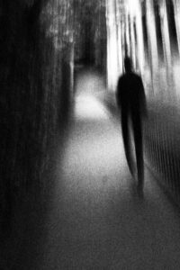 Fliss van Steenbergen: A photograph that looks like a charcoal sketch of a man in a dark alley