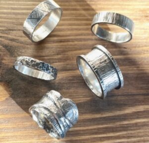 Nicola Jane: A selection of Oxidised textured rings made with recycled sterling silver.