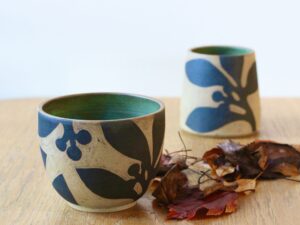 Leigh Hicks: A stoneware vase and bowl, decorated with botanical sgraffito in black