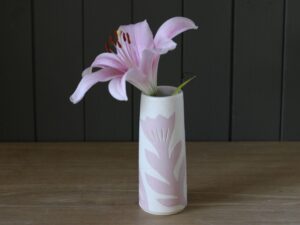 Leigh Hicks: A tall stoneware budvase with pink lily, decorated with botanical sgraffito in pink and white