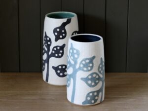 Leigh Hicks: Two stoneware vases, white blue and white with black, decorated with botanical sgraffito