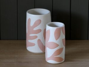 Leigh Hicks: Two stoneware vases, both white and pink, decorated with botanical sgraffito