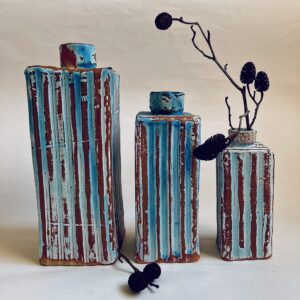 Sally Dorrity WOA: ribbed bottles, stoneware clay, dry blue glaze