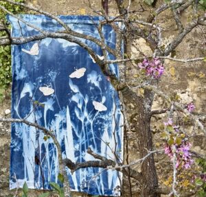 Catherine Rye: Gossamer One - A cyanotype whole cloth print on muslin of irises, cow parsley and clematis with embroidered silk butterflies and sil backing