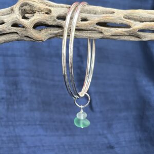 Alison Morris: Hammered sterling silver linked bangles with a sea glass dangle. Inner diameter 6.4 cm (medium)