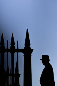 Fliss van Steenbergen: A silhouette of a porter standing by some railings