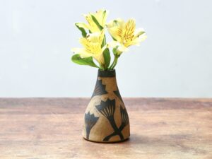 Leigh Hicks: A small stoneware budvase with yellow flowers, decorated with botanical sgraffito