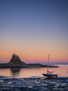 Stuart Feurtado: Linsidfarne Abbey silhouetted against evening sky