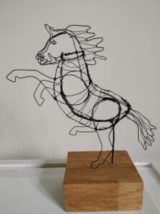 Val Hughes: Wire sculpture of a rearing horse.