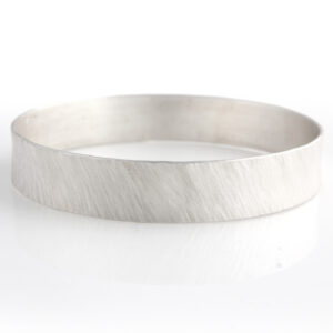 Emily Fermor: Wide 'rays' texture silver bangle in silver