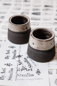 Ariadna Alvarez: Hand-thrown stoneware espresso cup with a raw clay body and speckled glaze. Small in scale, tactile in form.