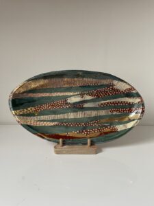 Elizabeth Newbery: 'Fish in Osney stream'. Dish decorated with slips and gold lustre.