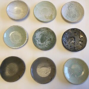 Sue Hill WOA: Little test dishes, trying to get the perfect glaze to describe lichen on stone.