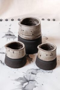 Ariadna Alvarez: Hand-thrown stoneware jugs in mini and large forms, finished with softly speckled glazes and raw clay bases. Designed to balance function, proportion, and texture.