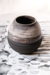 Ariadna Alvarez: Hand-thrown stoneware moon vase in black and white with exposed, textured clay.