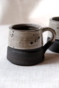 Ariadna Alvarez: Hand-thrown stoneware mug, finished with a soft speckled glaze and a raw clay base. Designed for daily use, celebrating texture, balance, and the beauty of subtle variation.