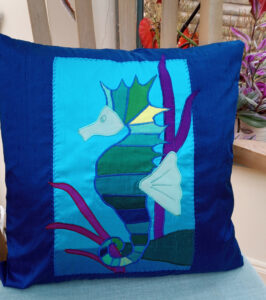 Lesley Russell Brown: Silk Applique Cushion ; Seahorse Scene on Dark blue.