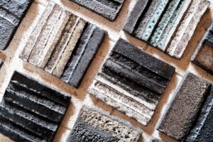 Ariadna Alvarez: Stoneware test tiles exploring experimental glaze recipes, surface variation, and layered finishes through controlled testing.